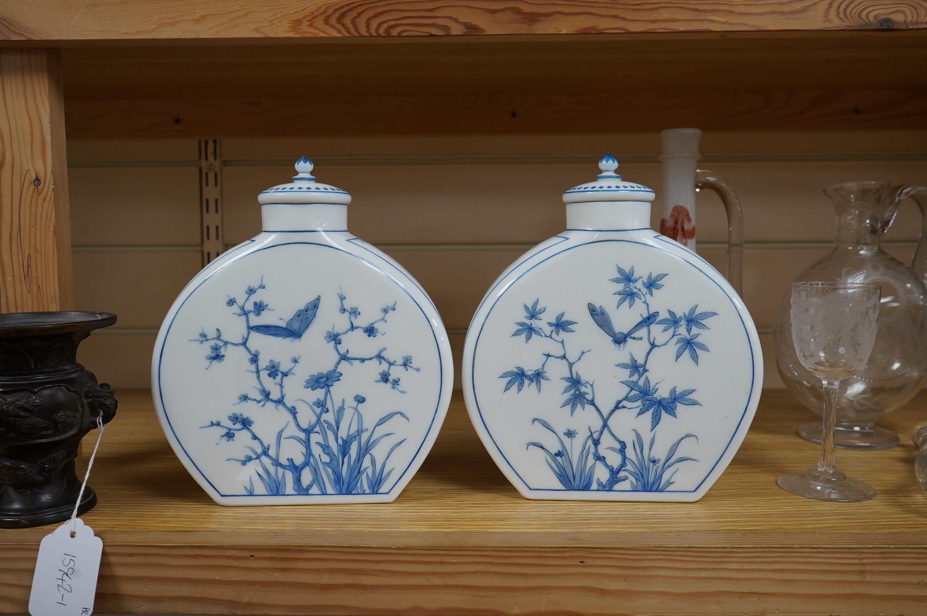 A pair of Victorian Aesthetic period enamelled opaque white glass moonflask vases decorated with children after W.S.Coleman, 23cm. Condition - one small chip found to inner rim of one cover, otherwise good.